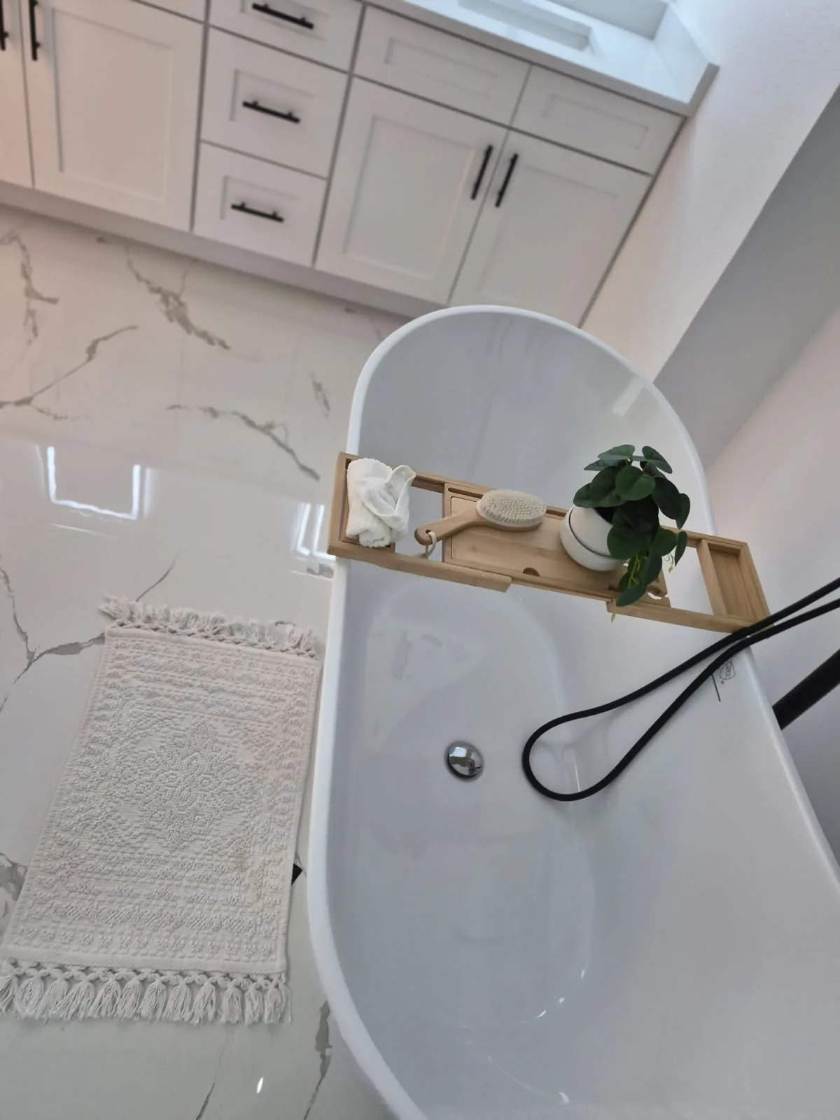 Freestanding bathtub and marble floor left sparkling clean