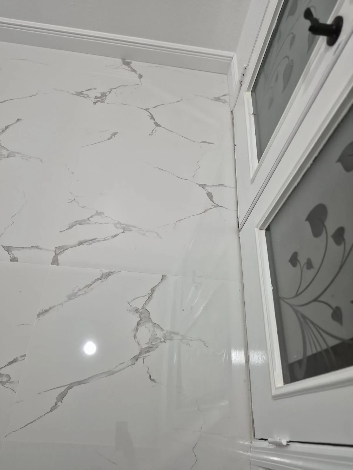 Close-up of gleaming white marble floor tile after cleaning