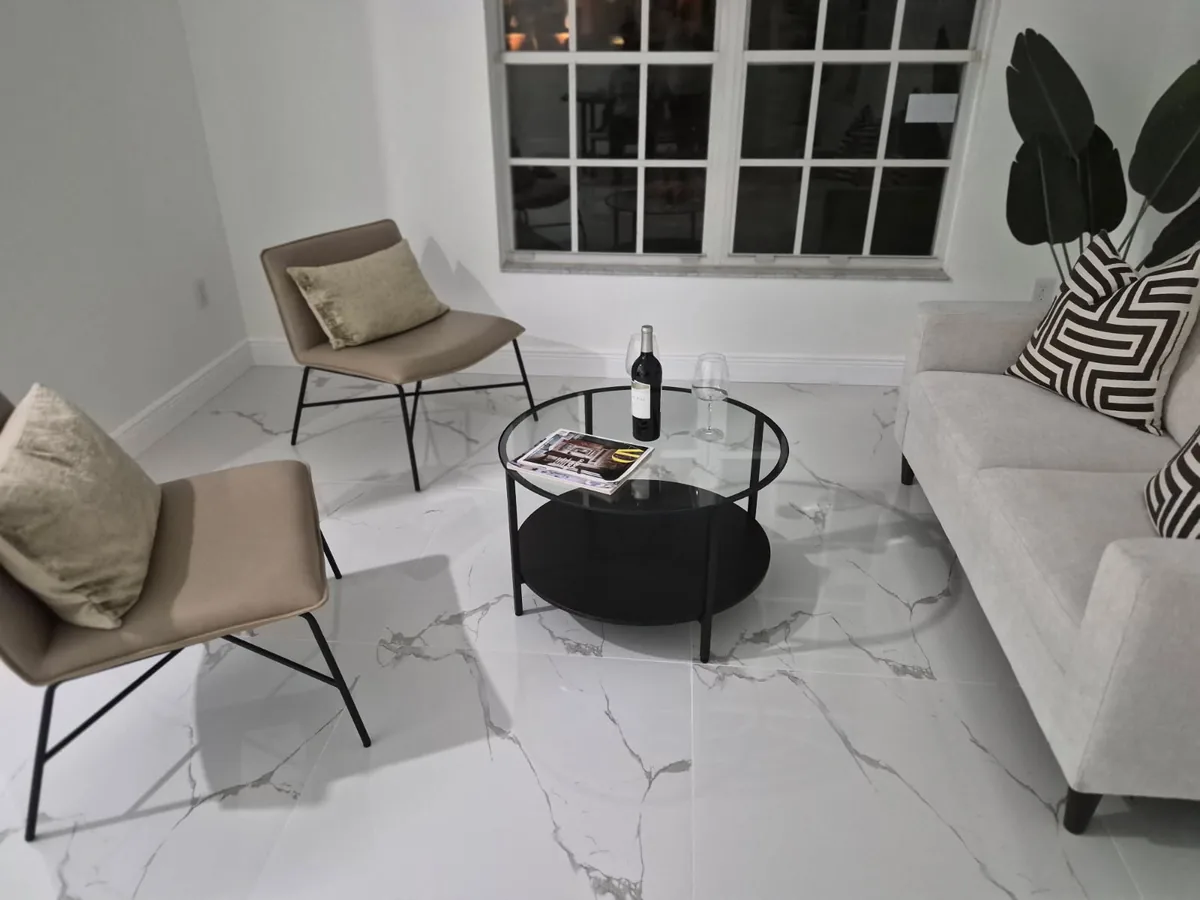 Sitting room with sofa and chairs, floors polished to a shine
